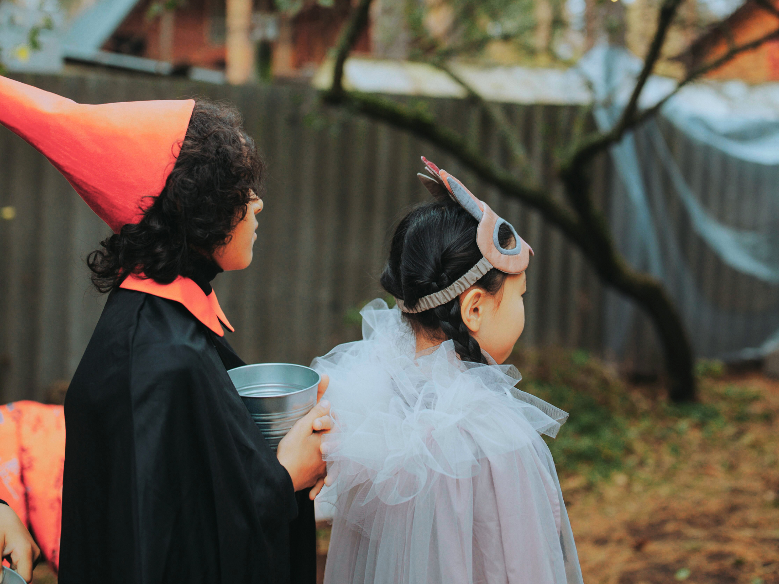 Two kids outside dressed up for Halloween